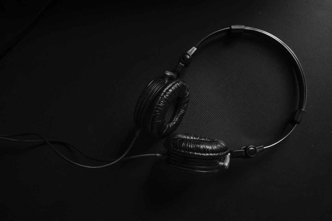Black headphones on a black surface.