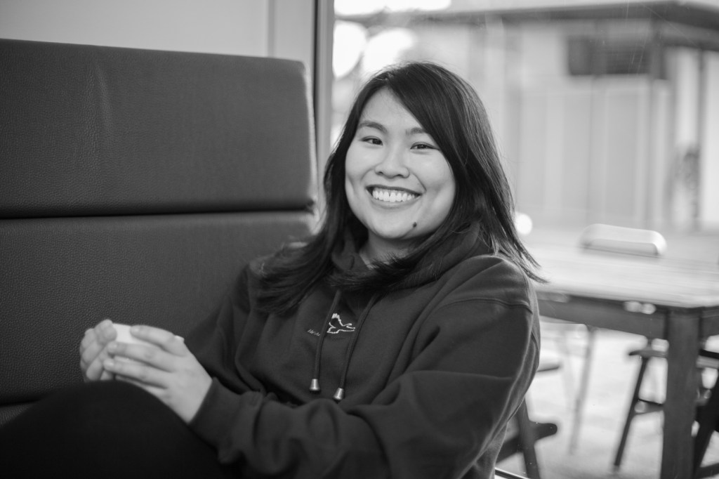 Lee-Ann smiling while holding a cup of tea.