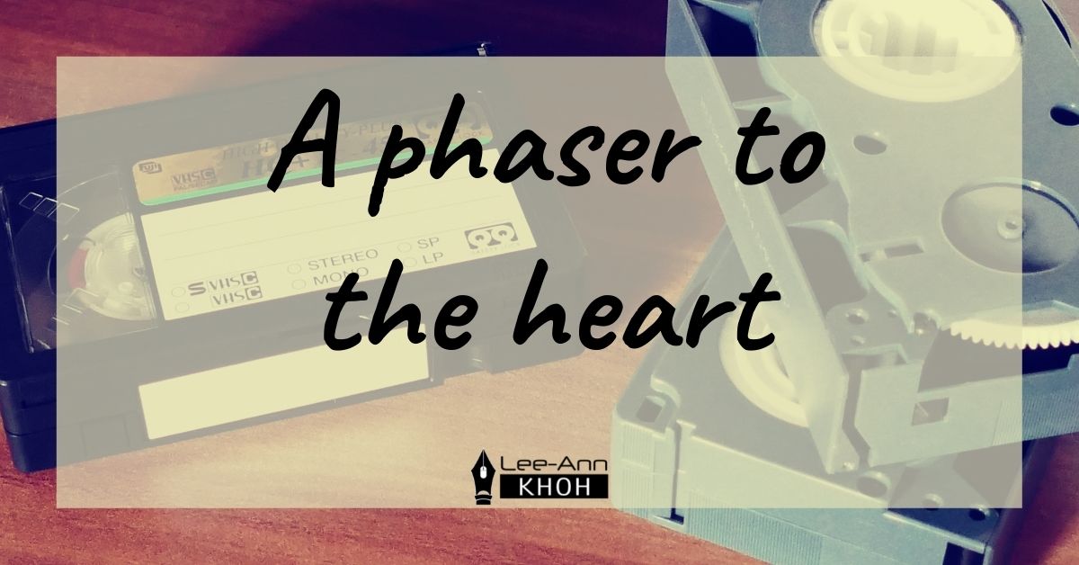 Text reads: A phaser to the heart. Background contains VHS tapes.
