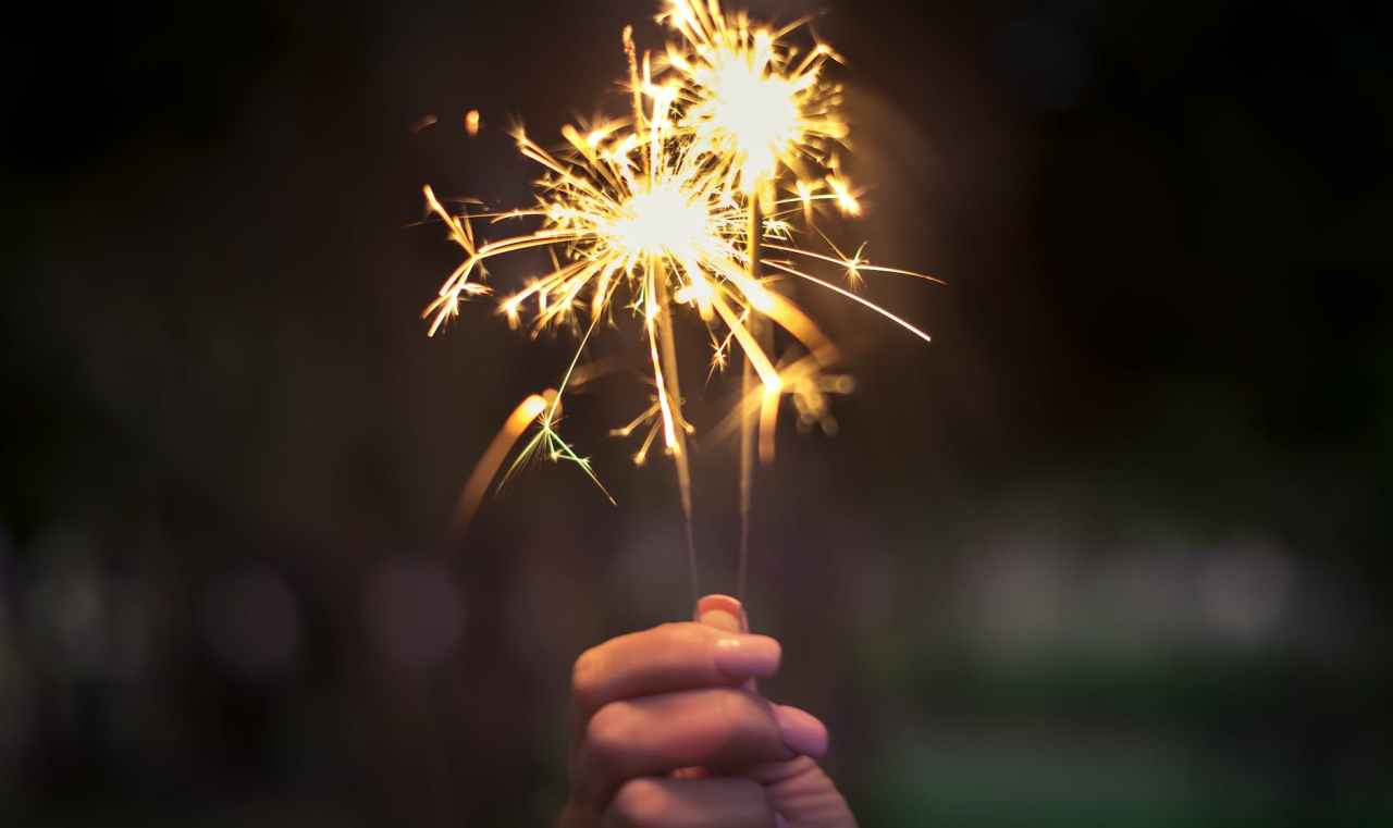 A hand holds a sparkler.