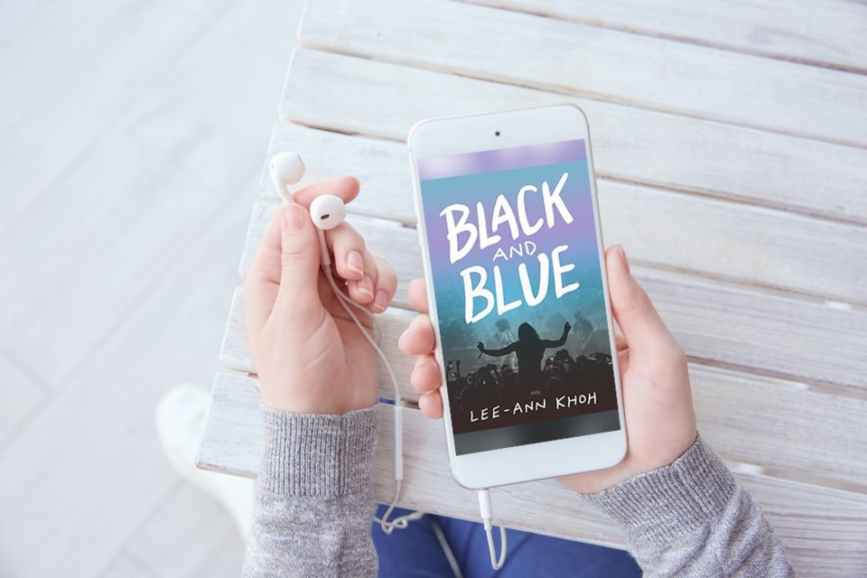 Mockup of a reader holding a mobile phone displaying Black and Blue by Lee-Ann Khoh, with earbuds plugged into a headphone jack.
